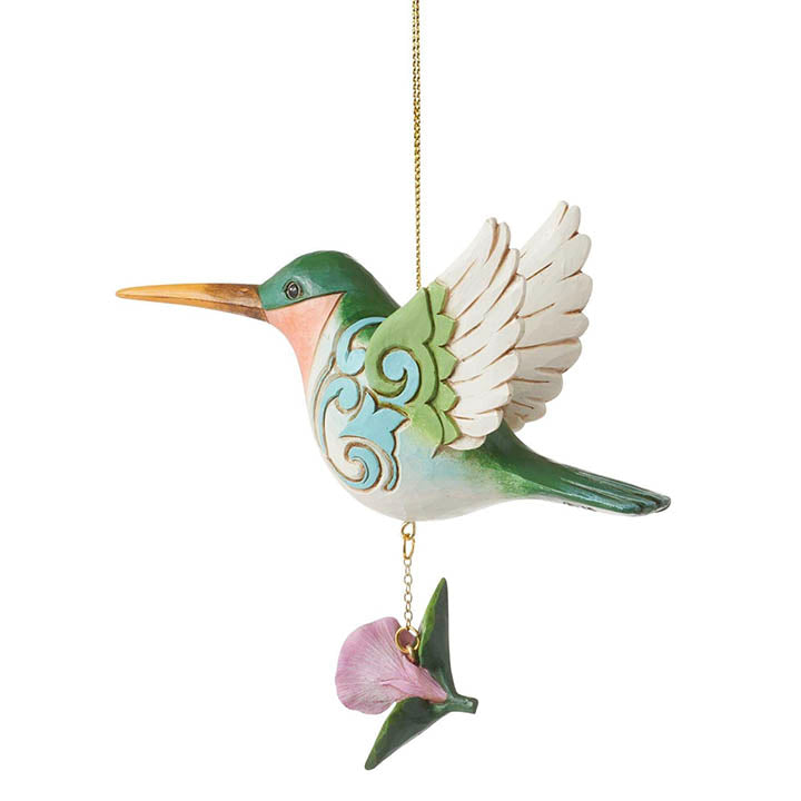 jim shore heartwood creek nature's meadow hummingbird ornament facing left hanging from gold cord with pink flower below