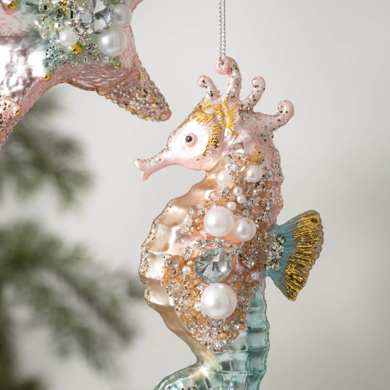 Detail of seahorse ornament with pearls and crystals on a blurred background