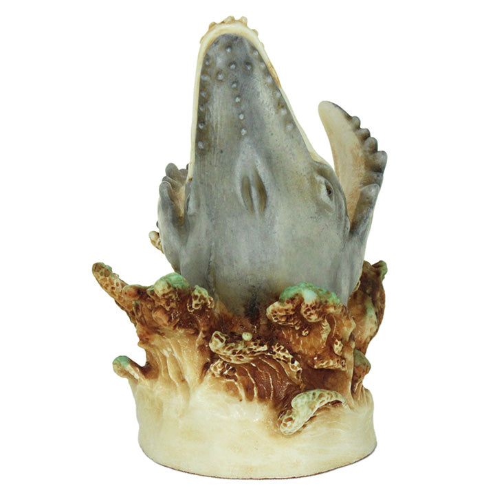 Decorative figurine of a whale's head emerging from a coral-like base on a white background