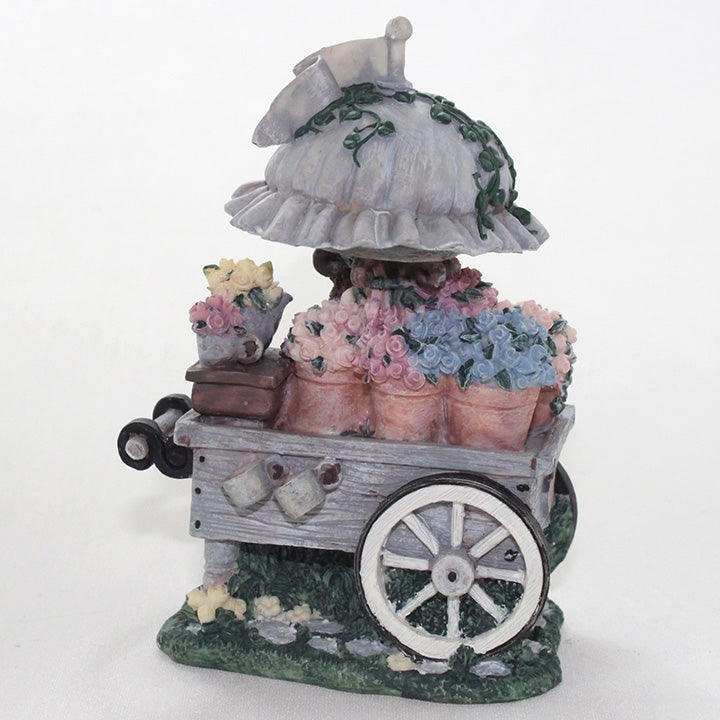 Decorative figurine of a flower cart 