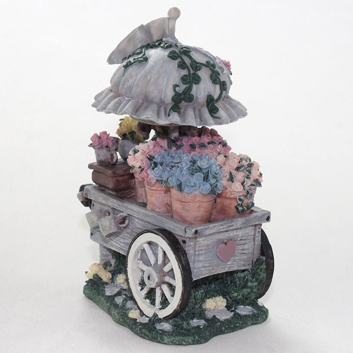 Decorative flower cart with flowers in pots