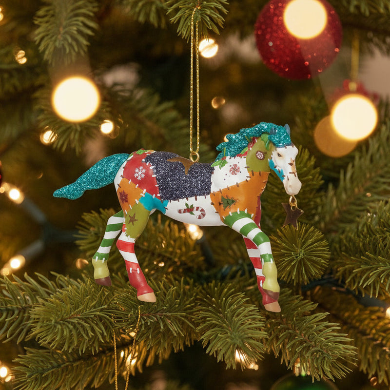 trail of painted ponies holiday patchwork ornament hanging in lighted Christmas tree