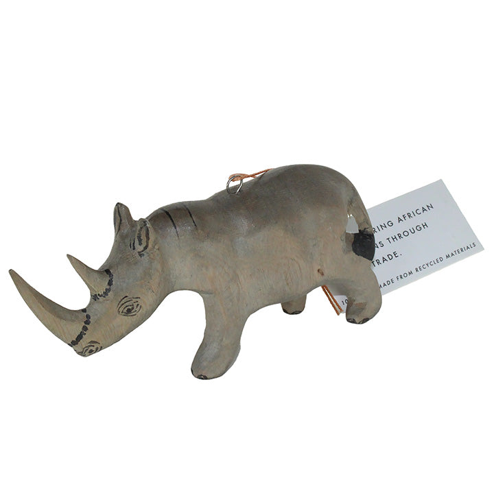 Carved wood rhino figurine ornament with a tag on a white background 