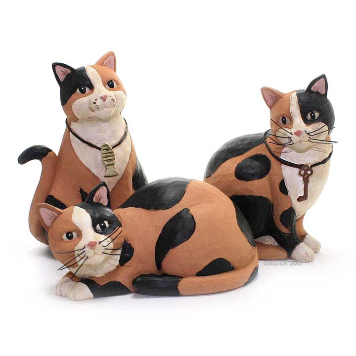 blossom bucket cat figurines - set of 3 calico cats in different poses; left cat wearing a collar with fish charm, right cat wearing a collar with a key charm, middle cat has no collar showing