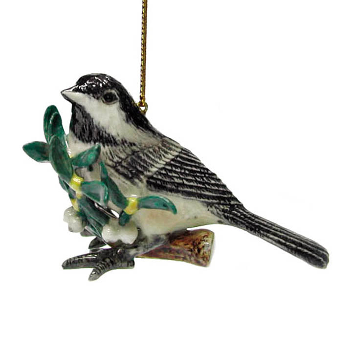 porcelain chickadee bird on branch with green leaves and yellow and white flowers left side view ornament hanging from gold colored cord
