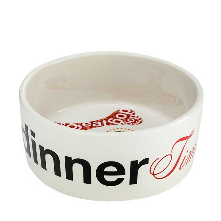 enesco, medium size ceramic designer dog food bowl or water dish - view of outer rim black and red "dinner time" text, part of interior graphics