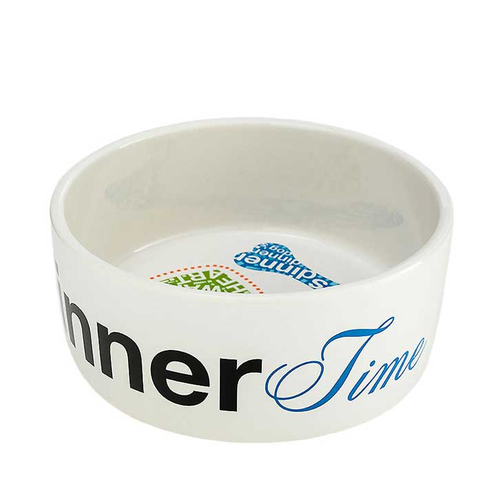 enesco, medium size ceramic designer dog food bowl or water dish - view of outer rim black and blue "dinner time" text, part of interior graphics