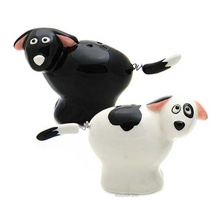 enesco, our name is mud ceramic dog salt and pepper shakers with moving spring tails - black dog pepper shaker, white dog with black spots salt shaker - front view
