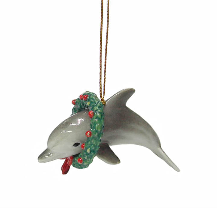 porcelain dolphin wearing a christmas wreath with red bow and decorations ornament view showing longer gold colored cord