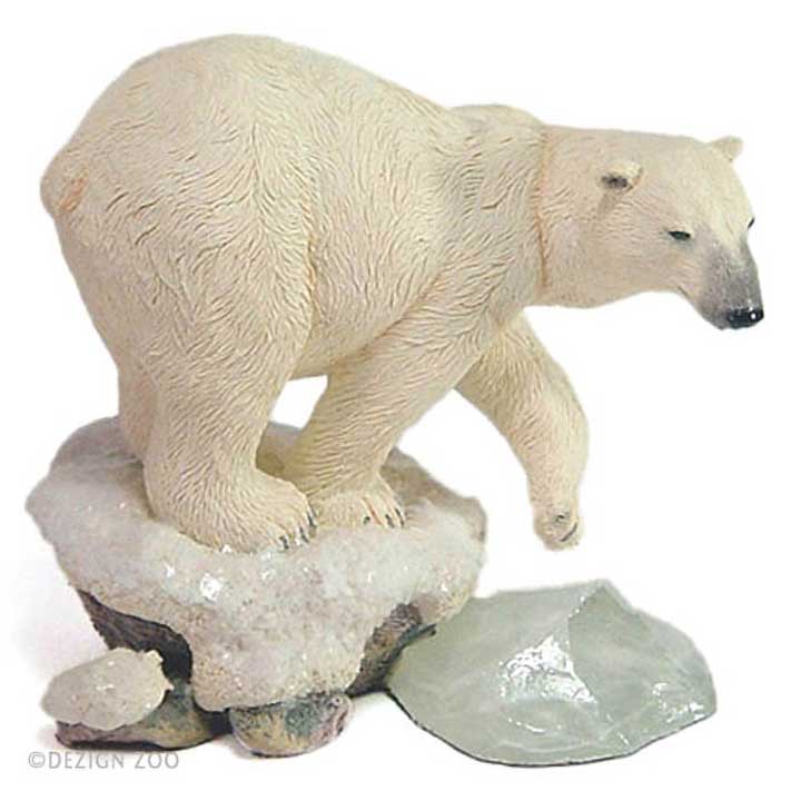 above right / semi-back view of country artists brand figurine of off-white polar bear stepping off sparkling white snow onto blue green ice