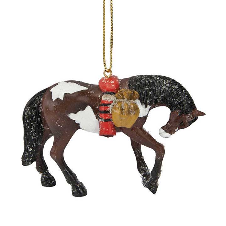 trail of painted ponies trail of tears ornament, a brown and white paint horse with head lowered carrying a blanket and satchel covered in snow - right side showing cord for hanging