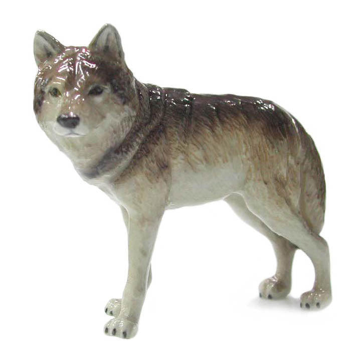 miniature porcelain gray wolf figurine standing looking forward left side view